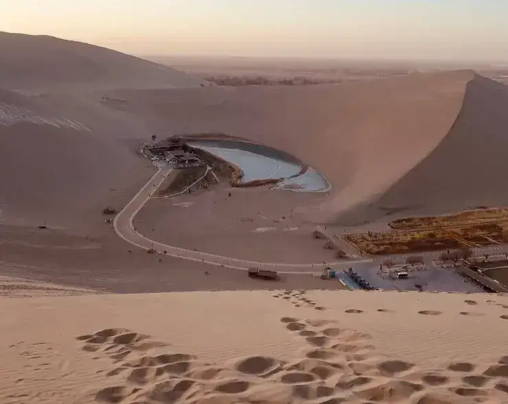 Crescent Moon Lake amid golden dunes